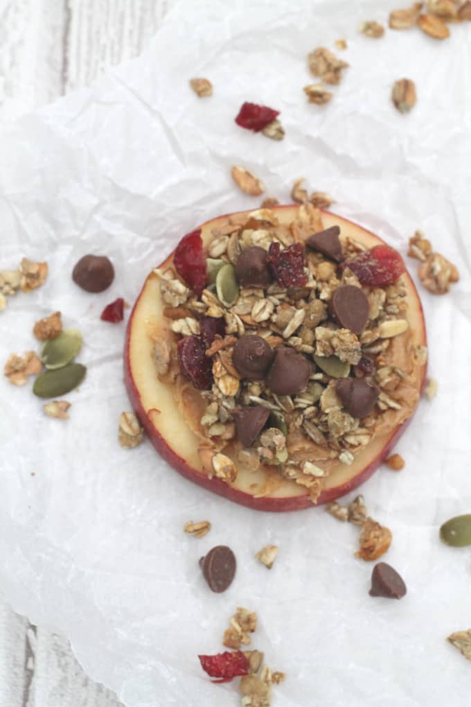apple slices topped with peanut butter, granola and chocolate chips