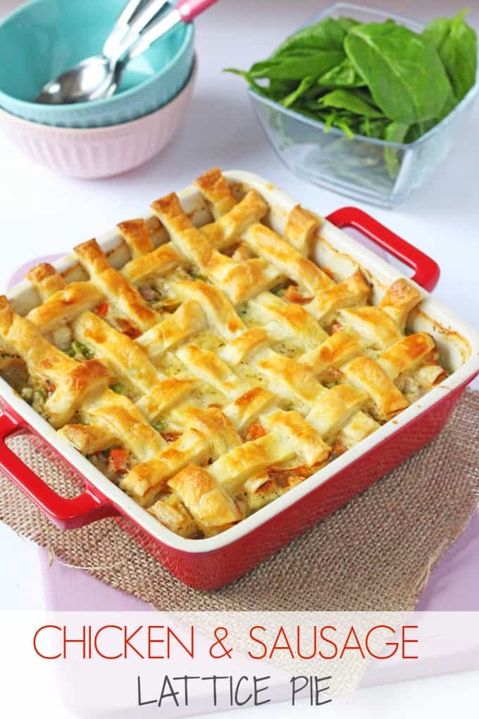Cheesy chicken & sausage lattice pie served in a red oven proof dish, fresh out of the oven.
