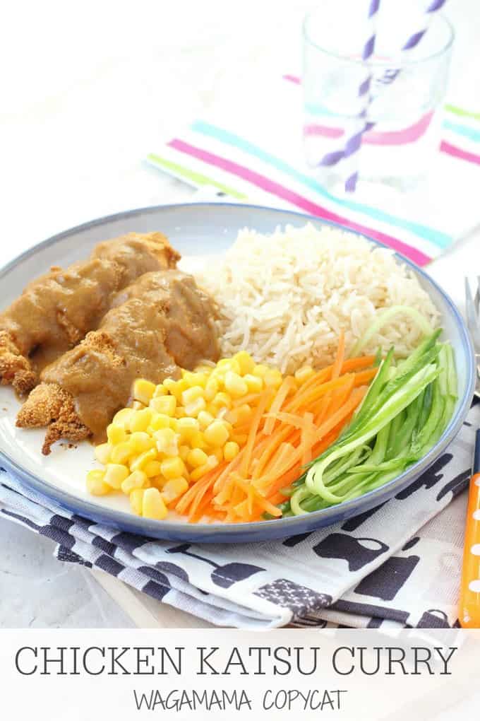 Chicken Katsu curry served on a white dinner plate alongside fluffy white rice and chopped veggies.