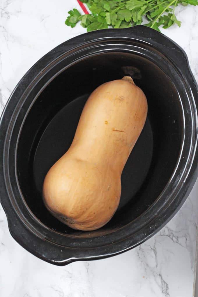 whole raw butternut squash in a slow cooker