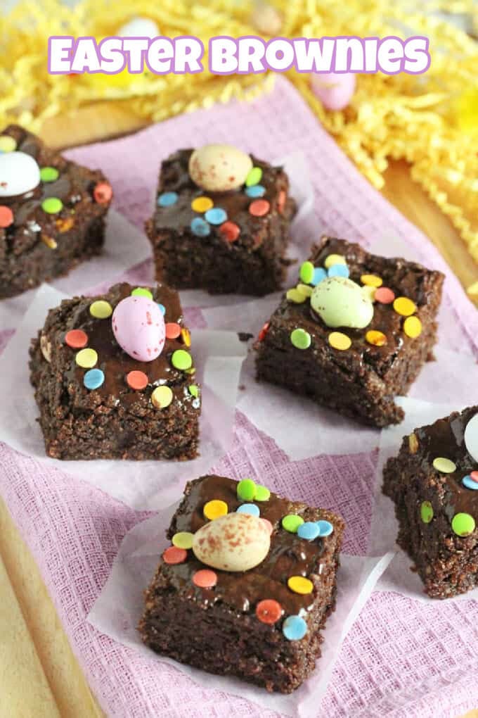 Mini Egg Brownies cut into small squares, toped with a Cadbury's mini egg and colourful confetti style sprinkles.