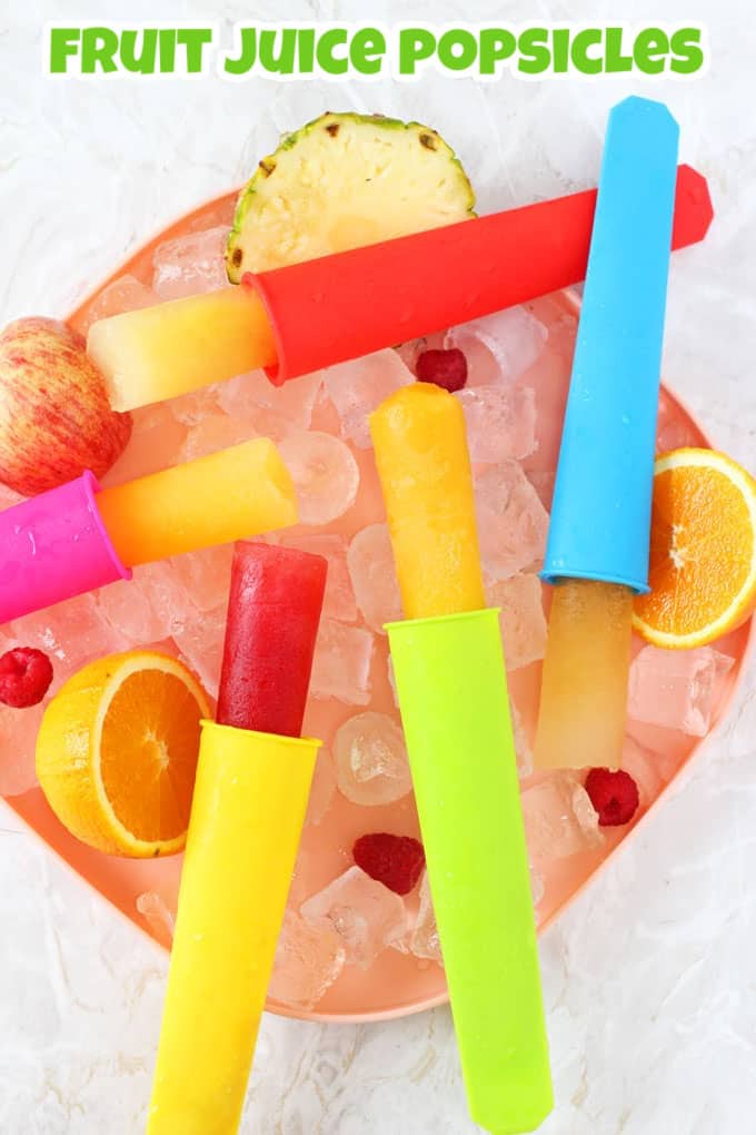 5 fruit juice popsicles in brightly coloured silicon popsicle mounds on a bed of ice in a bowl.