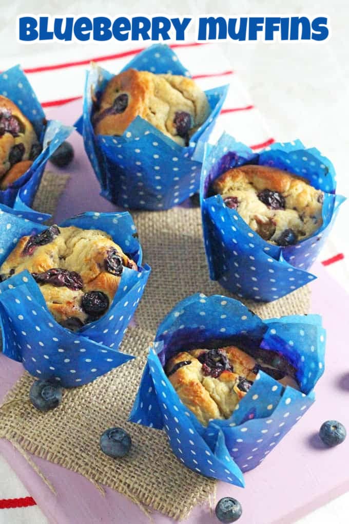 5 Blueberry Muffins in in blue and white polka dot muffin cases on a hessian background