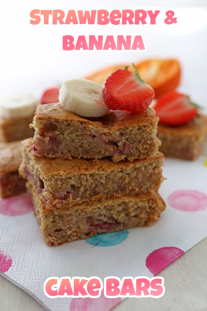3 squares of strawberry and banana cake bars stacked on top of one another with a slice of banana and half a strawberry on top.
