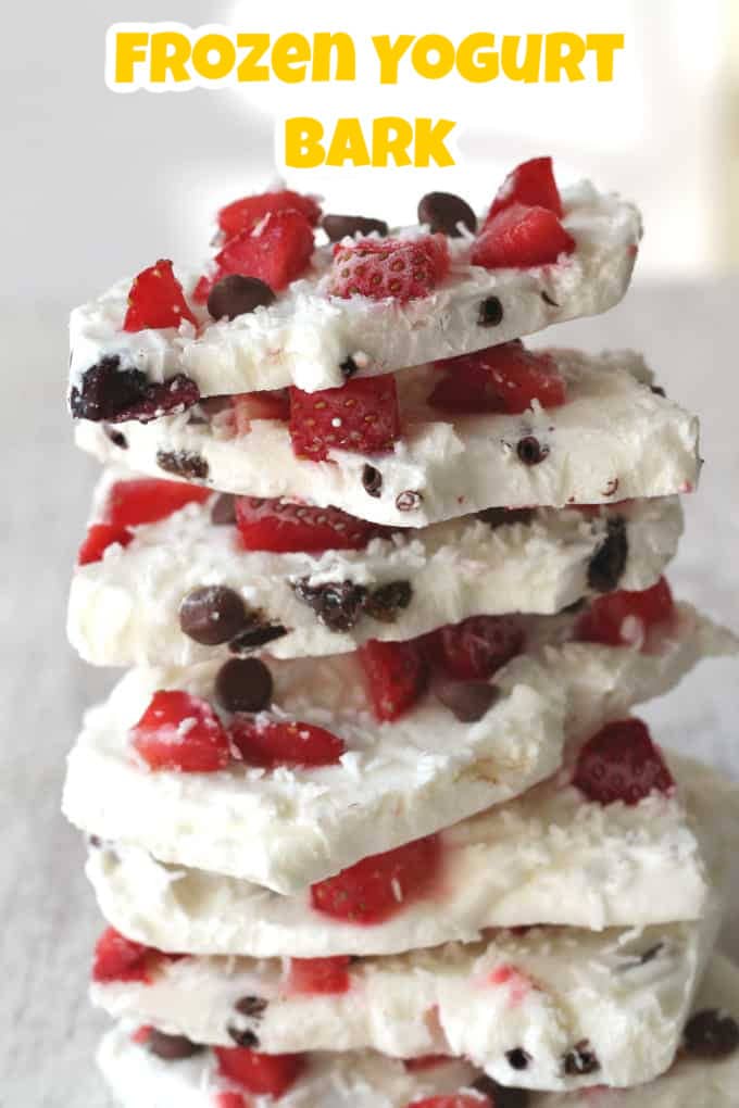 Frozen Yogurt Bark containing strawberries and chocolate chips broken into chunks and arranged in a stack.