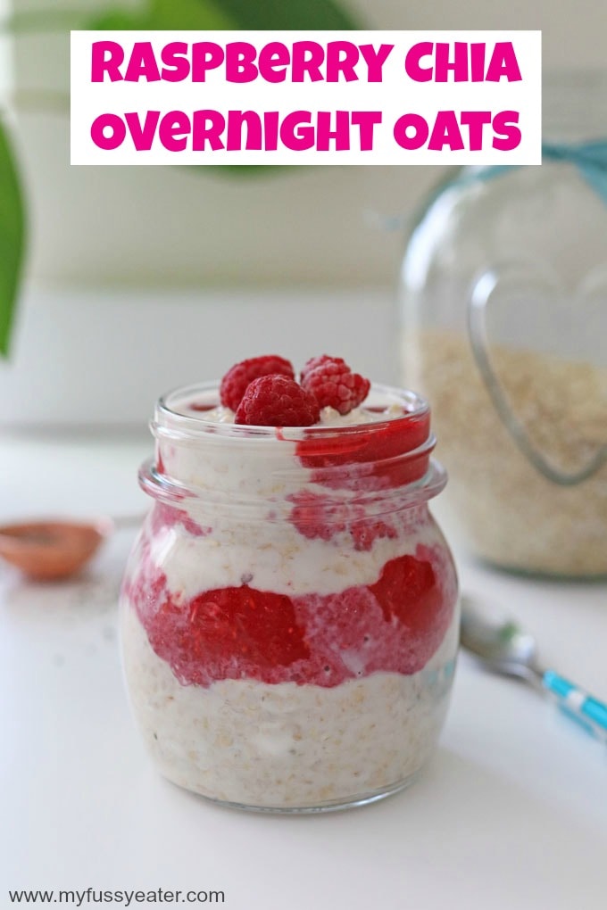 Raspberry & Chia Seeds Overnight Oats in a short glass jar with a glass pot of porridge oats in the background.