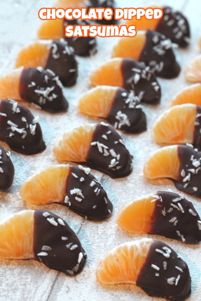 Chocolate Dipped Satsumas arranged in lines on a white wooden surface.