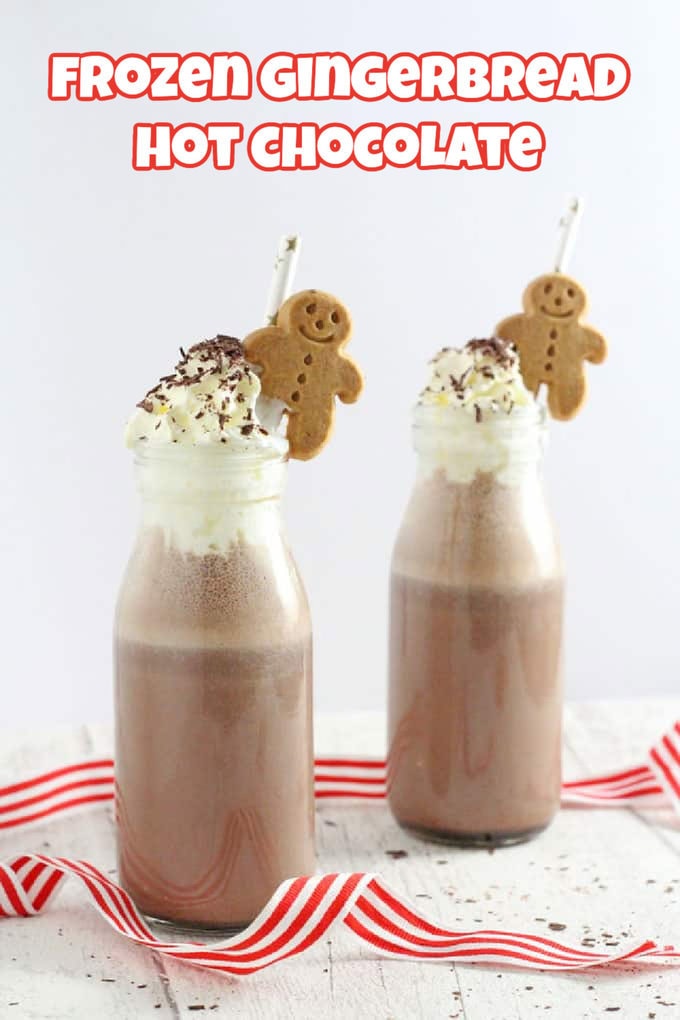 Two bottles of Frozen Gingerbread Hot Chocolate served in mini milk bottles, topped with whipped cream, chocolate sprinkles, mini gingerbread men and straws.