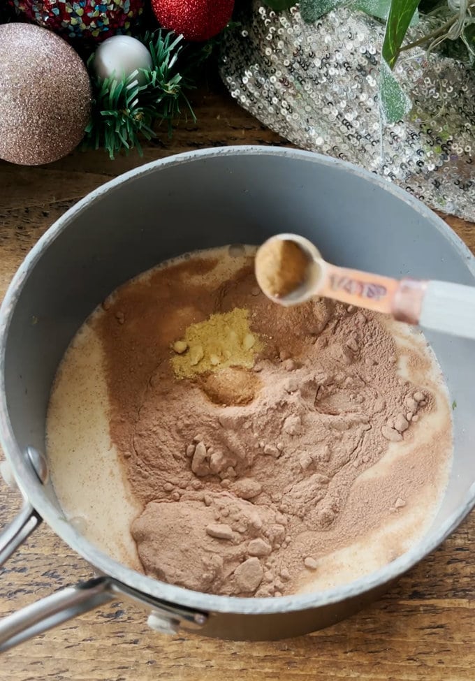 Ingredients being added into a saucepan.