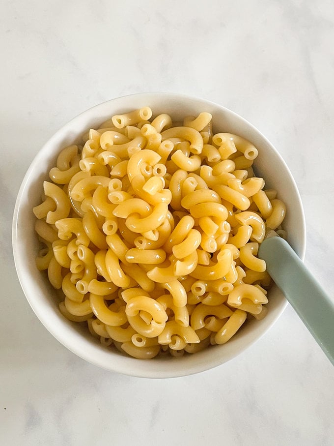 Cooked bone broth pasta served in a white round bowl.