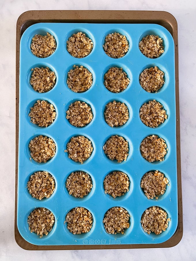 Ingredients added to a light blue silicone mini muffin tray.