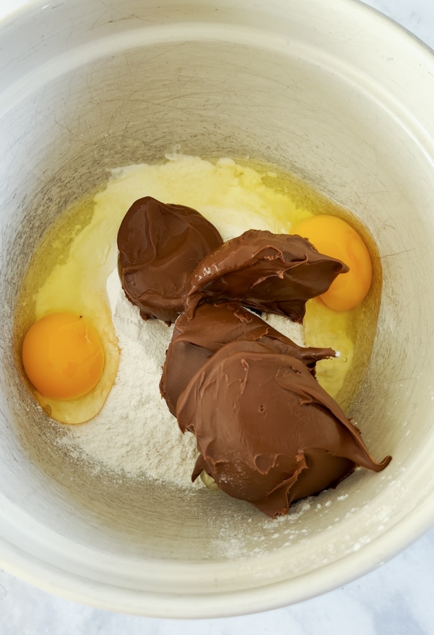 All the ingredients being combined in a large mixing bowl.