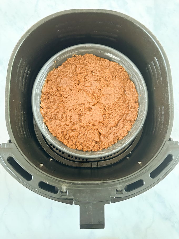 Cake added to the airfryer ready to be cooked.