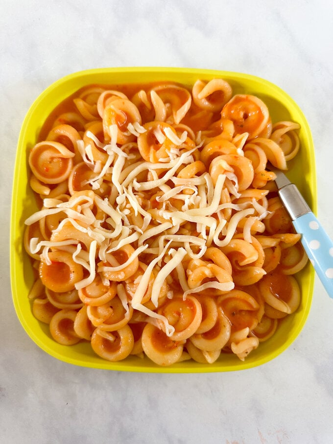 Soup also being served as a sauce, over pasta and garnished with grated cheese.
