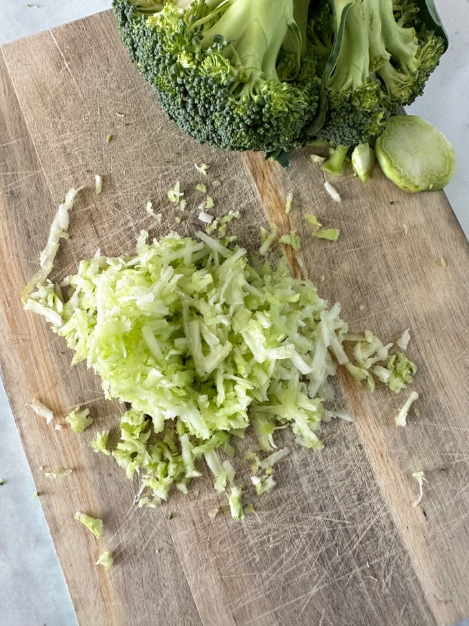 Broccoli stalk being grated.