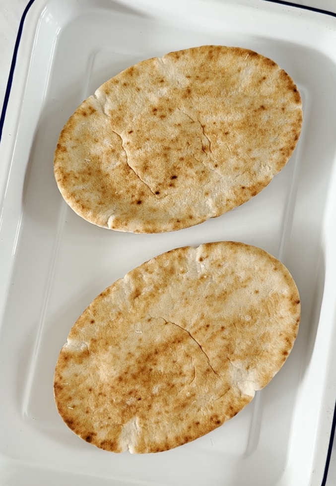 two plain pitta breads ready to be topped.