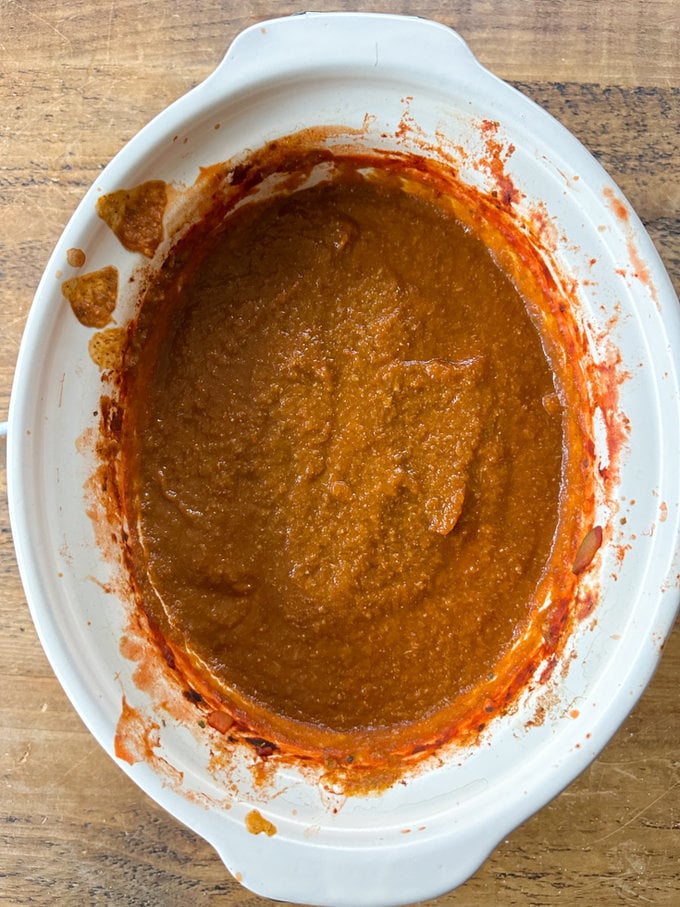 A hand blender is used directly in the slow cooker to blend up the sauce.