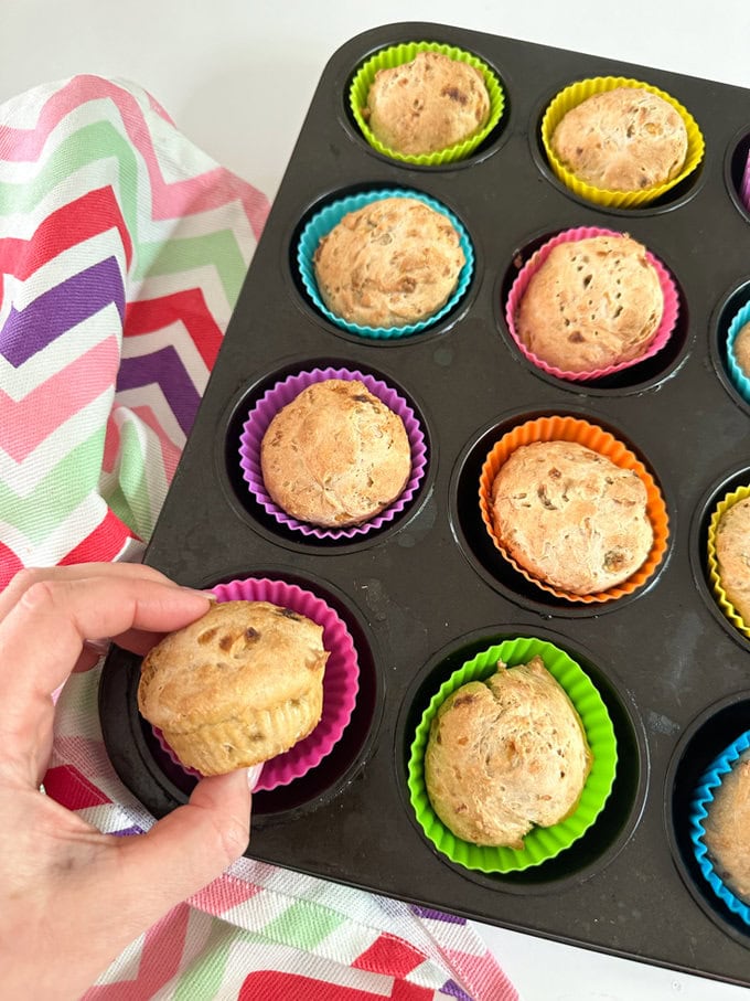 3 Ingredient Banana Muffins fresh out of the over in there brightly colored silicone muffin cases.