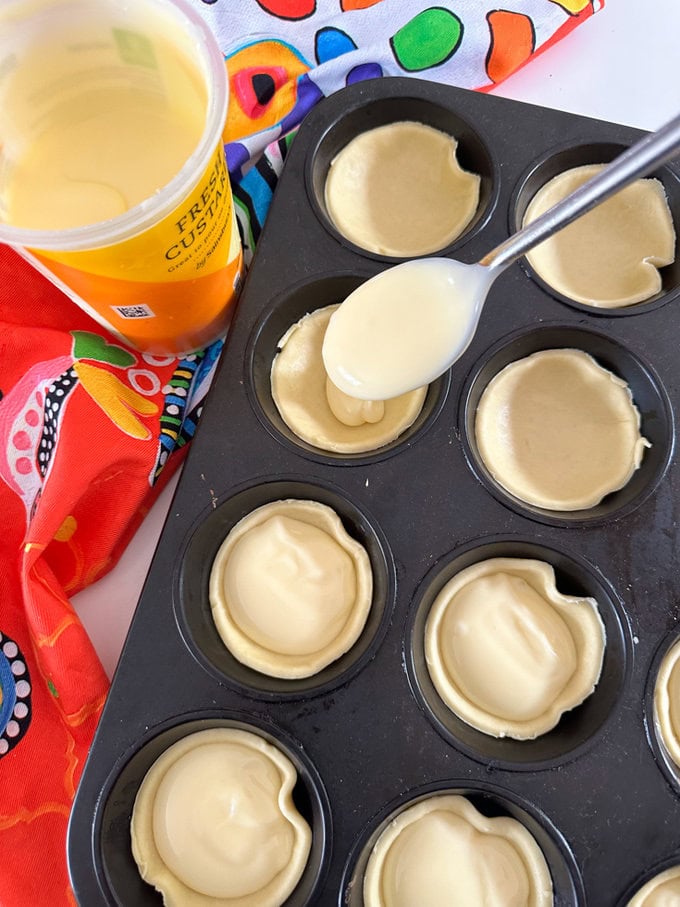 Custard being added using a spoon.