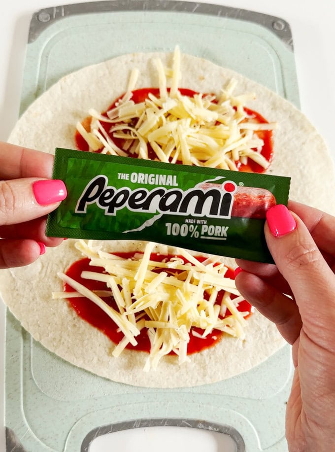 Chopped peperami being added to the wrap.