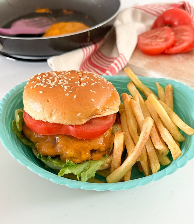 Tasty smash burger served with fries.