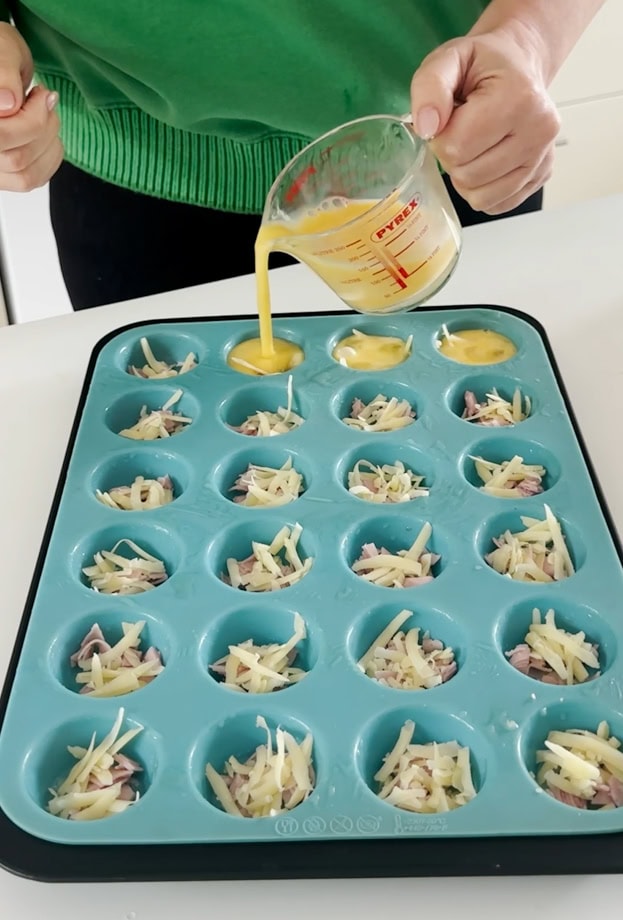 Egg mixture being poured using a glass jug.