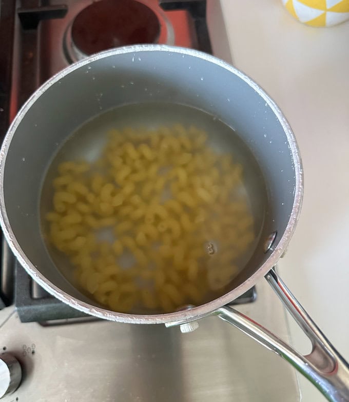 Pasta cooking in a pan of boiling water.