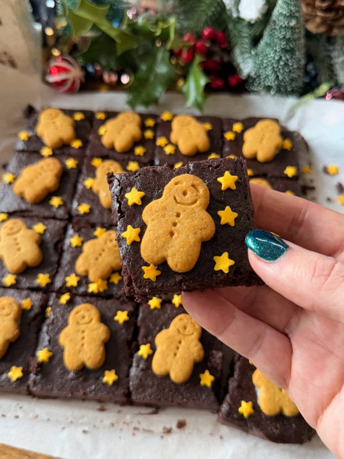 Gingerbread Brownies divided into equal pieces and decorated with mini gingerbread men and little gold star sprinkles.