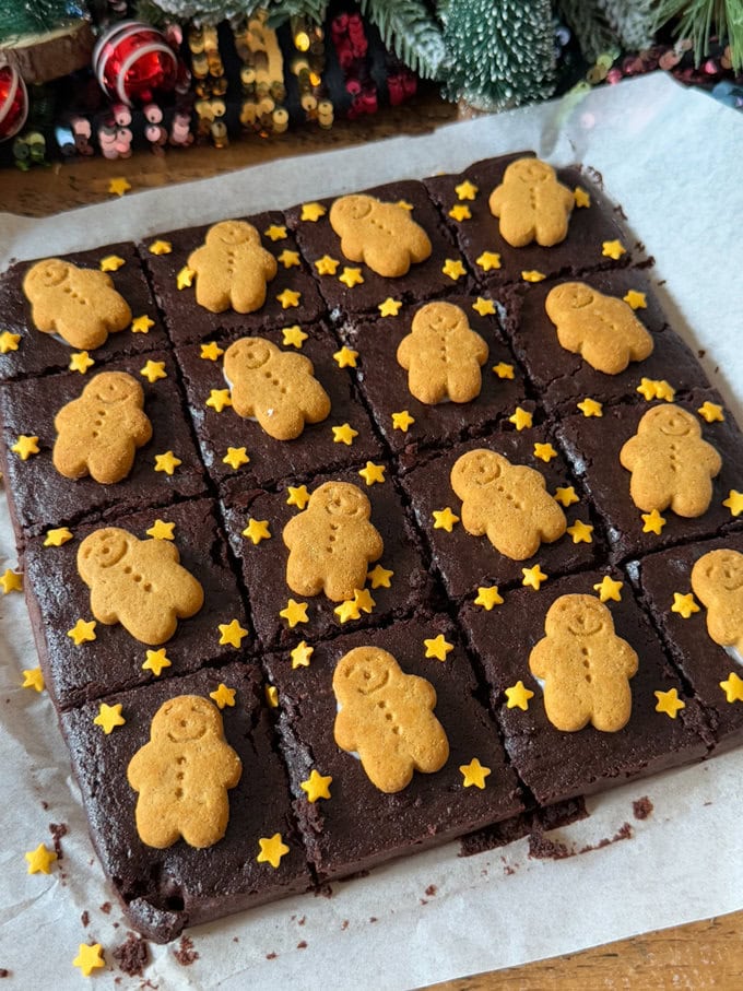 Gingerbread Brownies divided into equal pieces and decorated with mini gingerbread men and little gold star sprinkles.