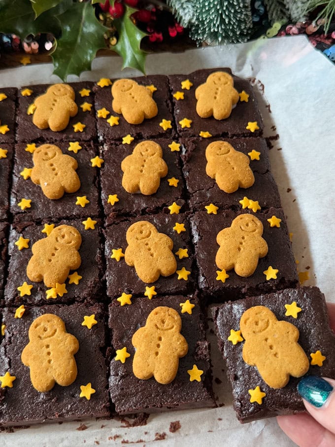 Gingerbread Brownies divided into equal pieces and decorated with mini gingerbread men and little gold star sprinkles.