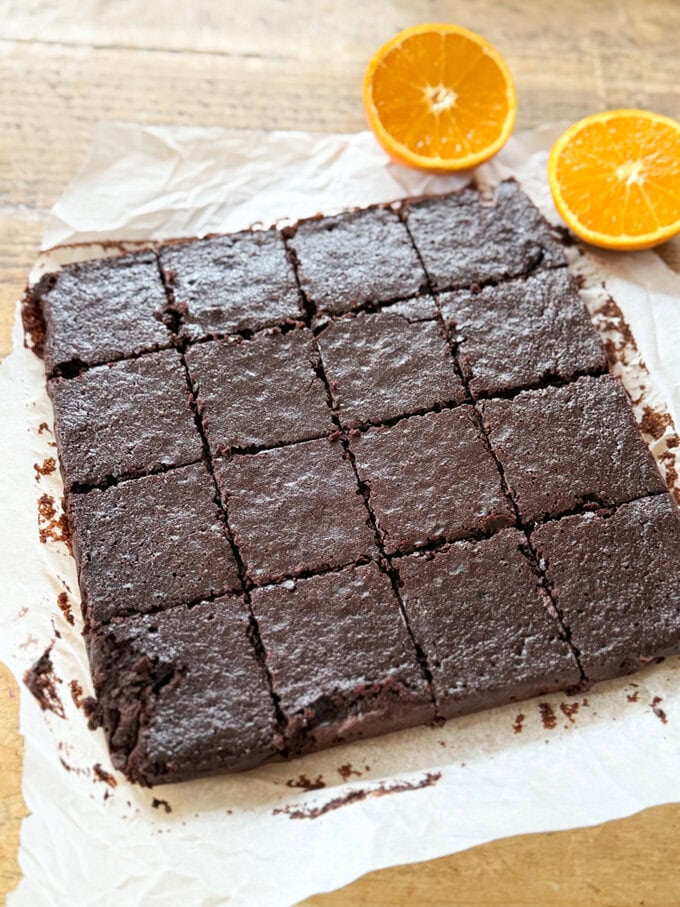 A slab of Chocolate Orange Black Bean Brownies cut into individual squares.