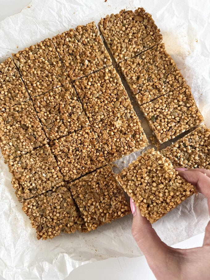 Quinoa flapjacks fresh out of the oven and being cut into equal squares ready to be served.