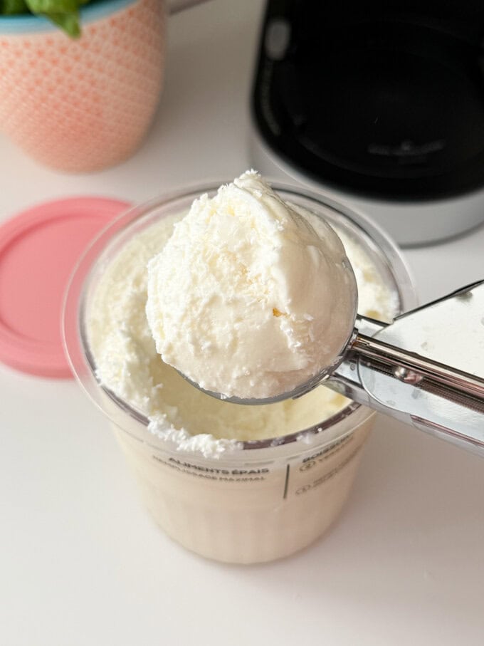 Ninja Creami Coconut Frozen Yogurt shown in a ice cream scoop.