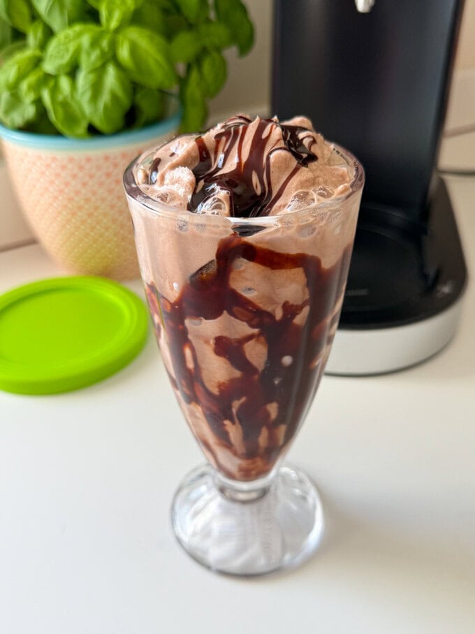 Ninja Creami Chocolate Milkshake served in a tall clear milkshake glass.