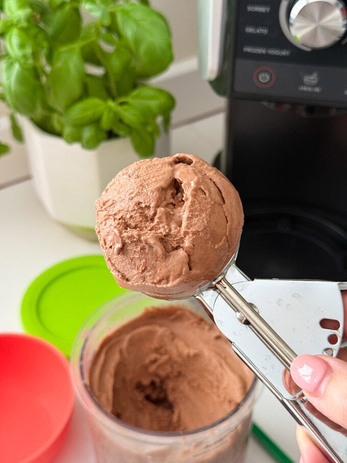 Ninja Creami Chocolate Frozen Yogurt being served using a stainless steel ice cream scoop.