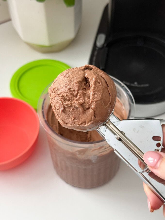 Ninja Creami Chocolate Frozen Yogurt being served using a stainless steel ice cream scoop.