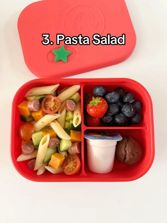 Pasta Salad served in a bright red kids lunchbox.