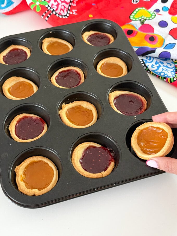 Jam tarts fresh out of the oven in a oven proof Muffin/cupcake tray.