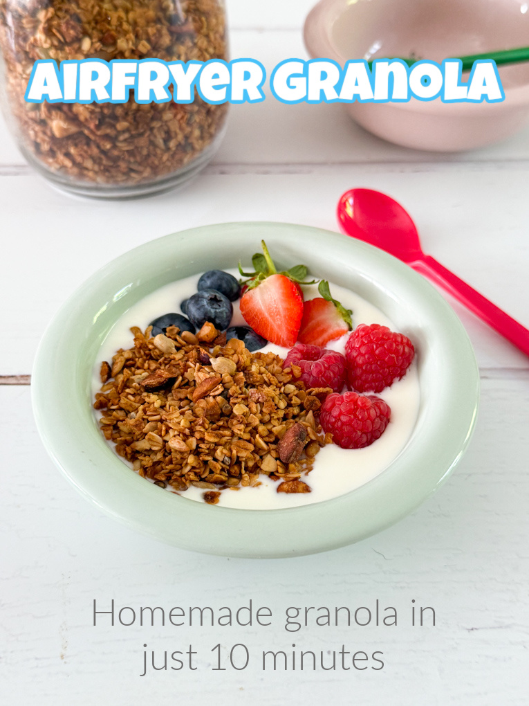Healthy homemade granola served in a breakfast bowl with fresh fruit and greek yogurt.