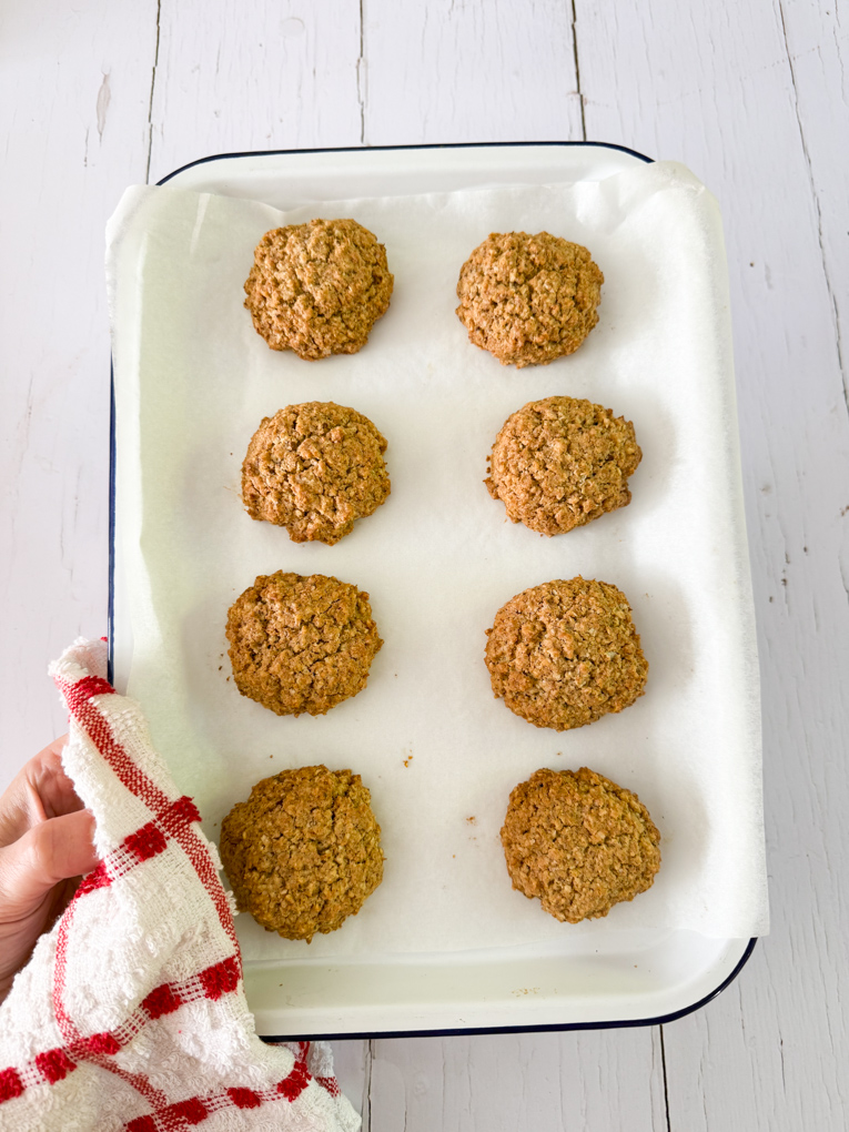 Cookies arranged on a baking tray fresh out of the oven.